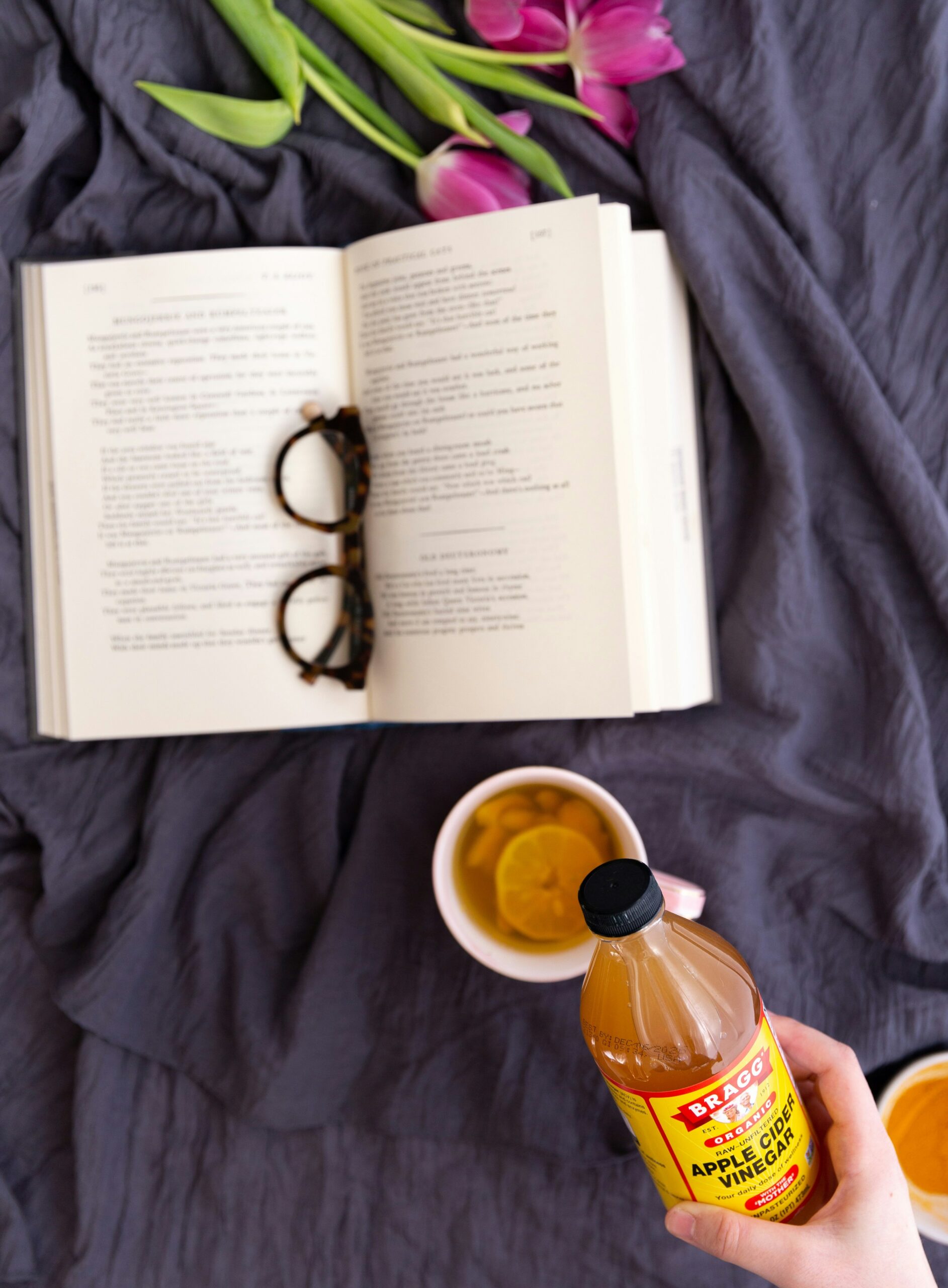 picture of a bragg apple cider vinegar pic with a plan on a book